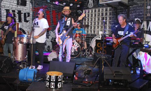 Five-piece band performing live on a club stage.